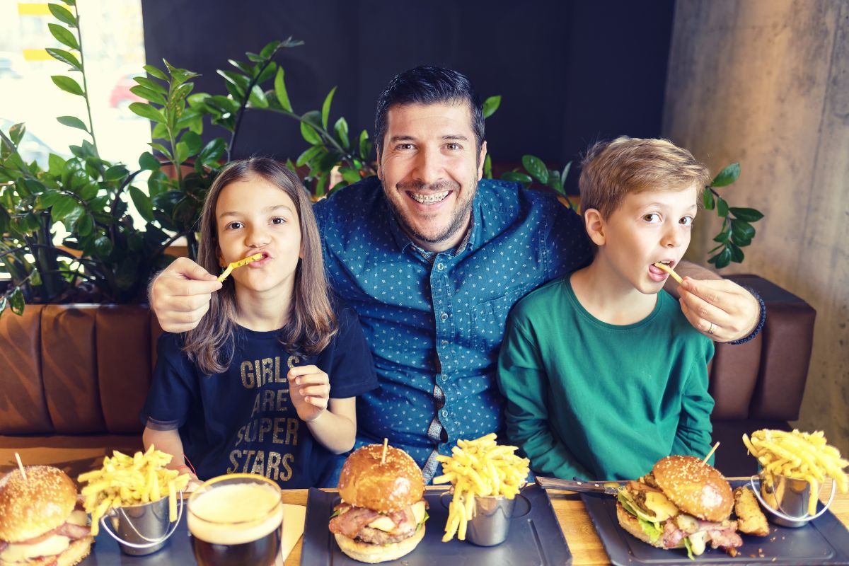 Family smiling together while discussing braces safe holiday food choices
